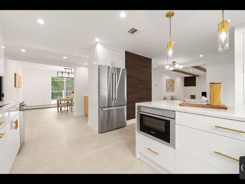 White kitchen with island and stainless appliances
